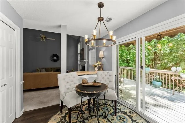 a view of a dining room with furniture wooden floor and a chandelier