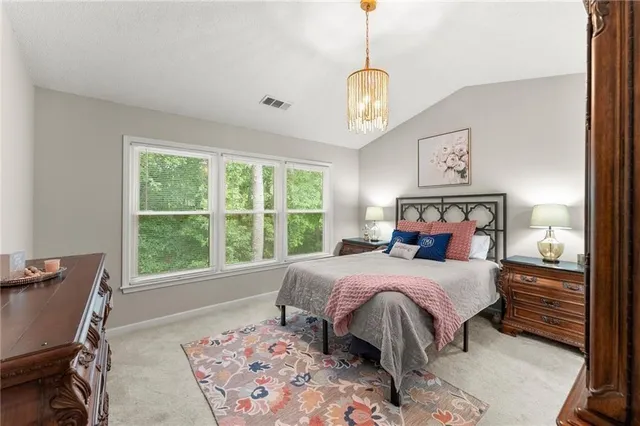a bedroom with a large bed and a window