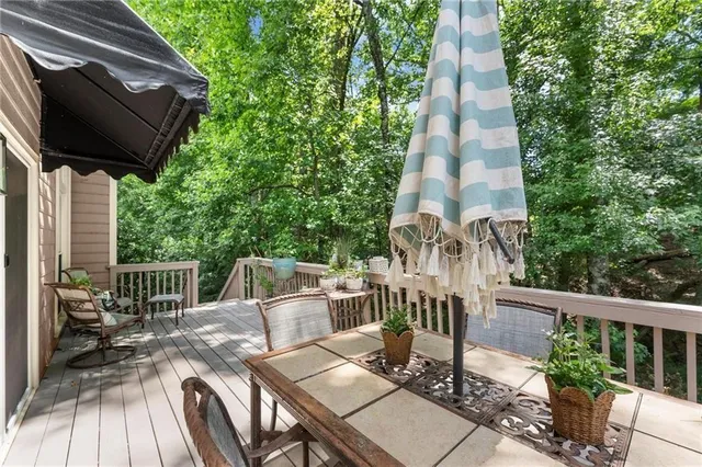 a view of balcony with wooden floor and outdoor seating