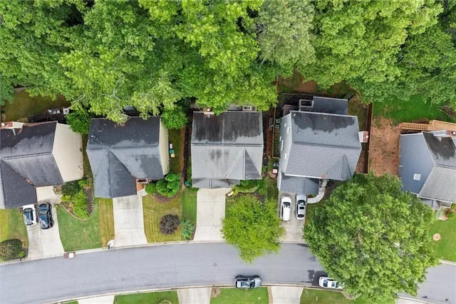 an aerial view of a house with yard and green space