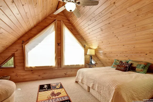 a bed sitting in a bedroom next to a window