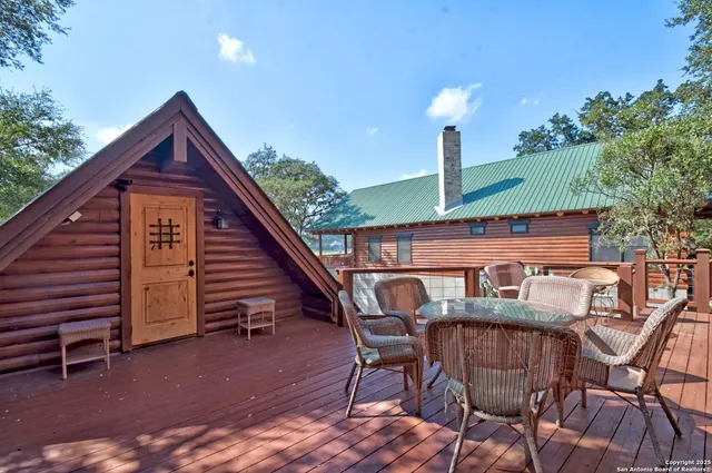 a view of a chairs and table in the backyard