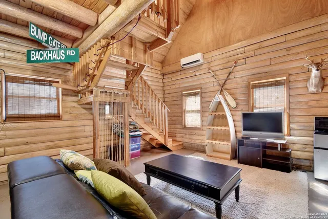 a living room with furniture a flat screen tv and a table