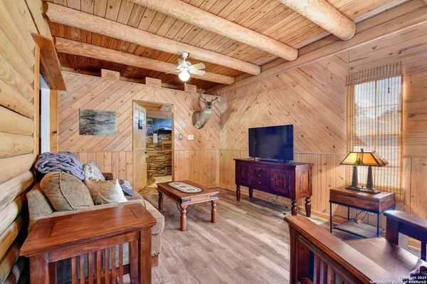 a outdoor living space with furniture and a flat screen tv