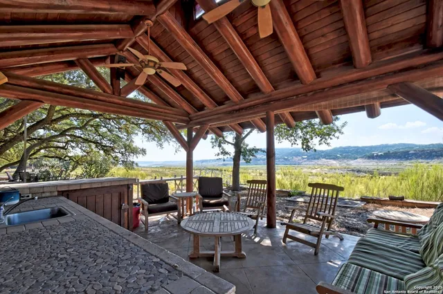 a view of a chairs and table in the balcony