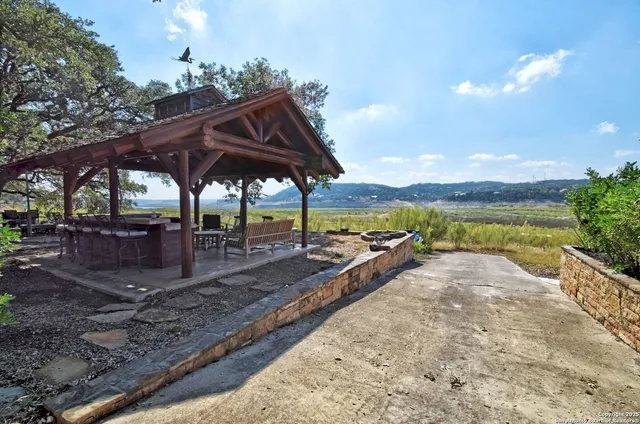 a view of a table and chairs under an umbrella