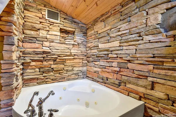 a bathroom with a bathtub and shower
