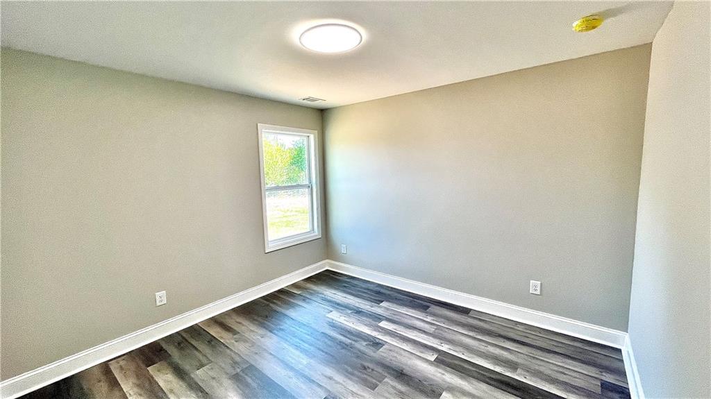 5 Green Road Griffin, GA 30224 - Photo 24 of 34 a view of an empty room with wooden floor and a window