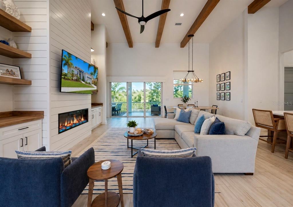 5605 Seagrass Place Apollo Beach, FL 33572 - Photo 11 of 86 a living room with fireplace furniture and a large window
