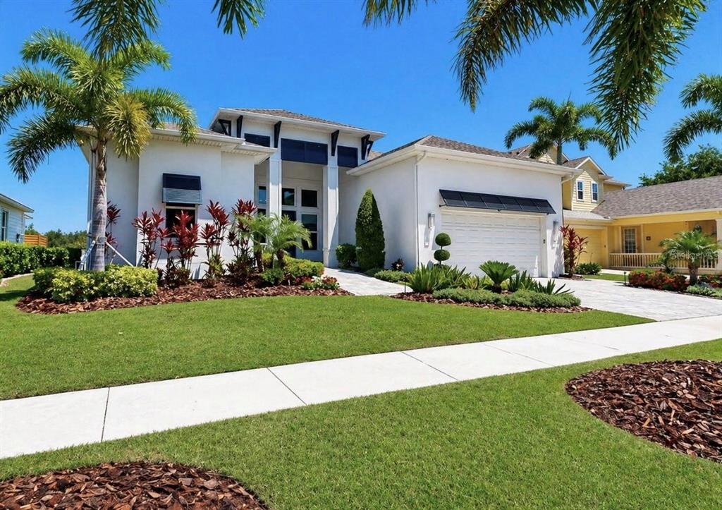 5605 Seagrass Place Apollo Beach, FL 33572 - Photo 2 of 86 a front view of a house with a garden