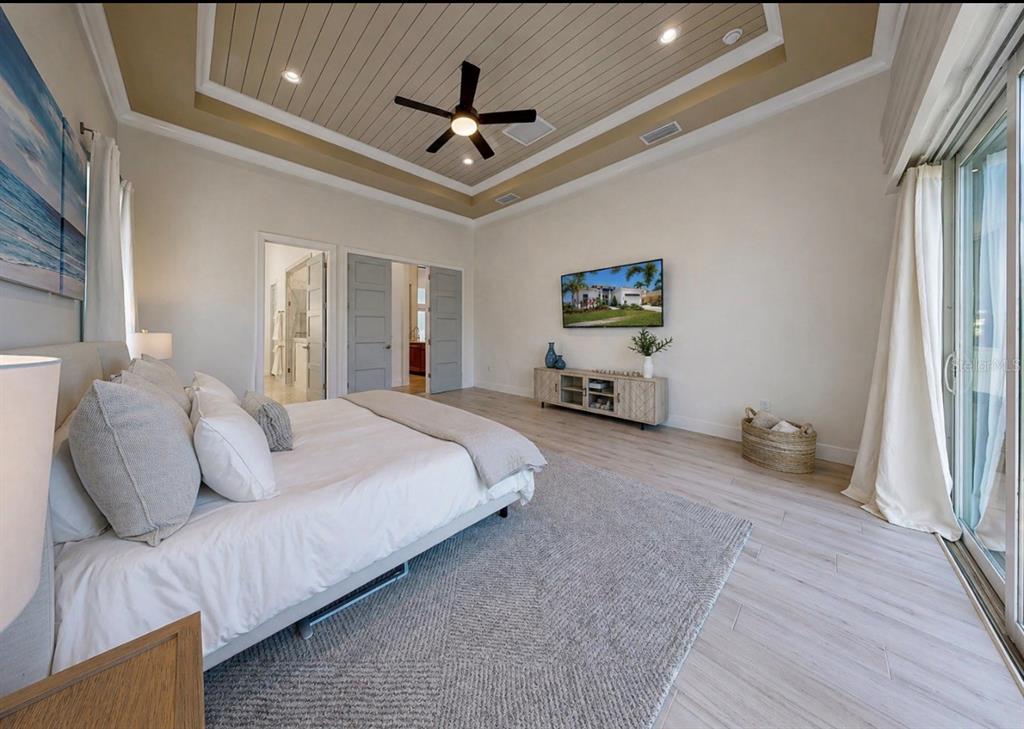 5605 Seagrass Place Apollo Beach, FL 33572 - Photo 34 of 86 a bedroom with a bed ceiling fan and a window