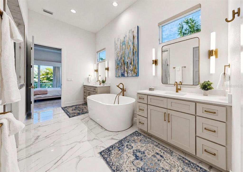 5605 Seagrass Place Apollo Beach, FL 33572 - Photo 38 of 86 a spacious bathroom with a double vanity sink a mirror and a bathtub