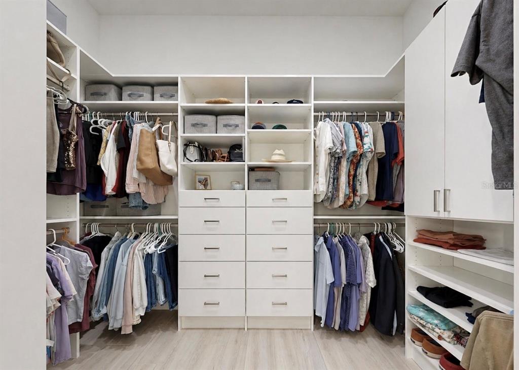 5605 Seagrass Place Apollo Beach, FL 33572 - Photo 40 of 86 a view of walk in closet with clothes and shoes