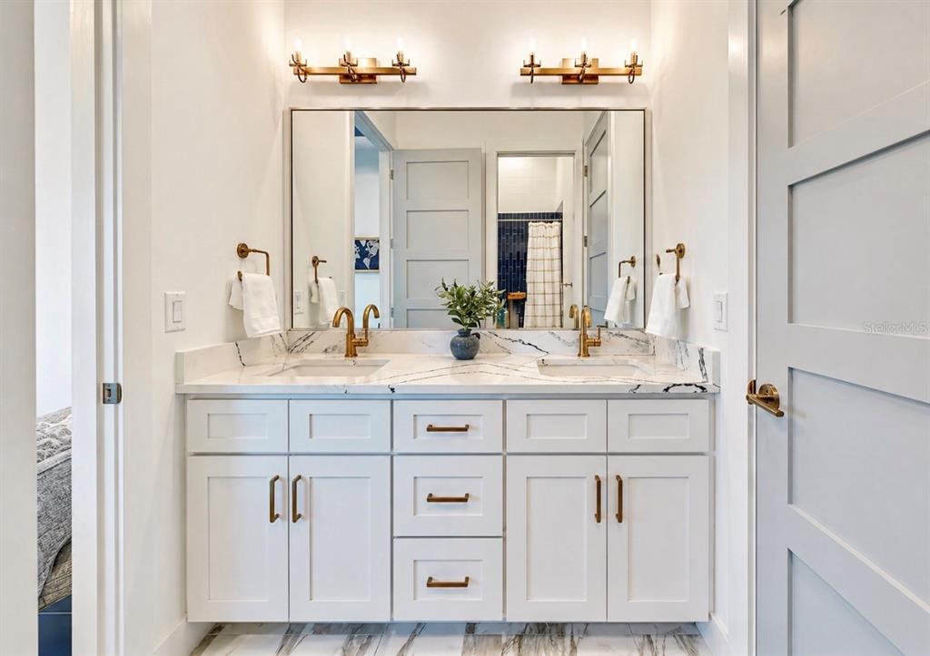 5605 Seagrass Place Apollo Beach, FL 33572 - Photo 42 of 86 a bathroom with cabinets sink and two mirror