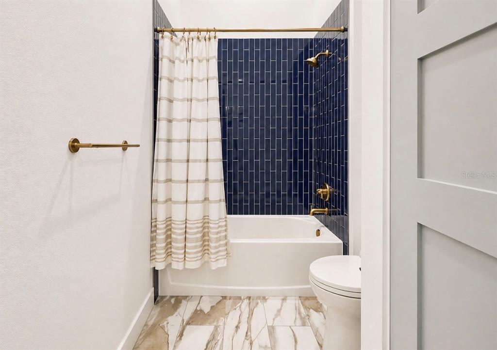 5605 Seagrass Place Apollo Beach, FL 33572 - Photo 43 of 86 a bathroom with a bathtub and a shower