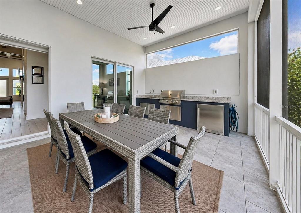5605 Seagrass Place Apollo Beach, FL 33572 - Photo 57 of 86 a dining room with furniture a rug and a chandelier