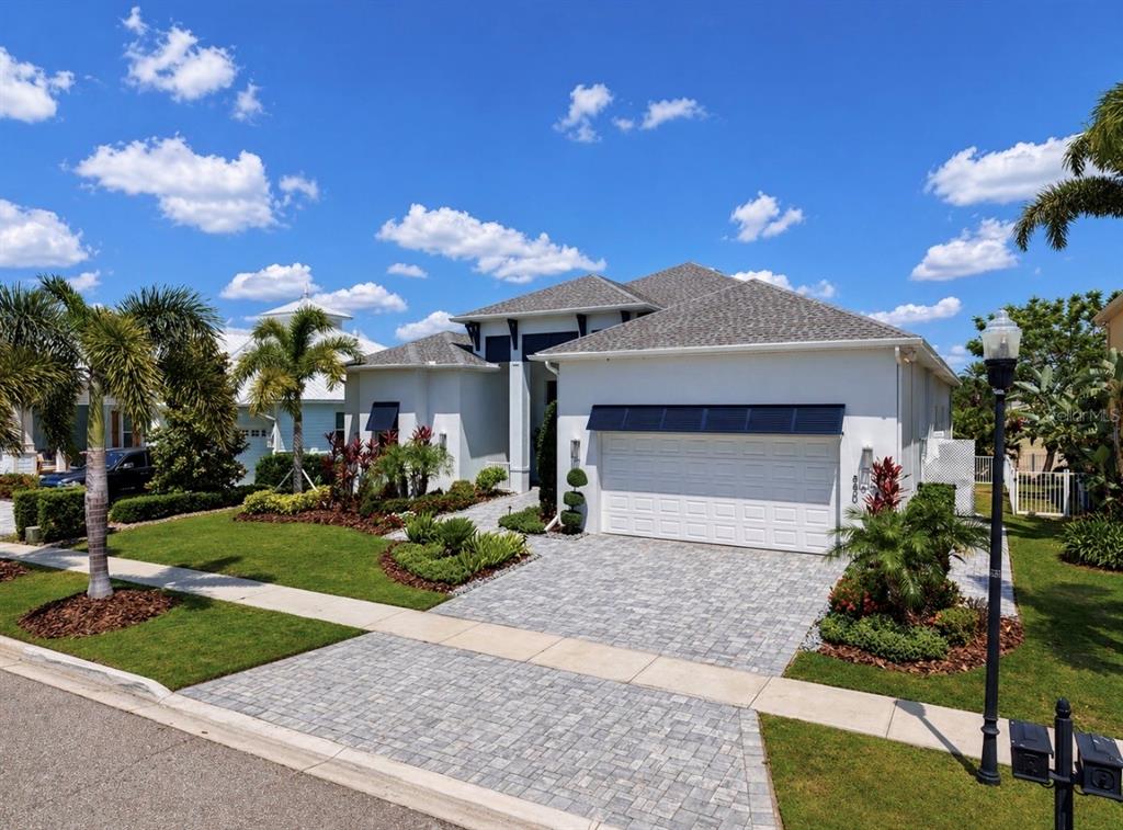 5605 Seagrass Place Apollo Beach, FL 33572 - Photo 62 of 86 a front view of a house with a garden and yard