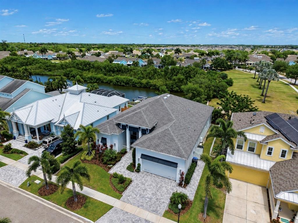 5605 Seagrass Place Apollo Beach, FL 33572 - Photo 65 of 86 an aerial view of a house with a garden and lake view