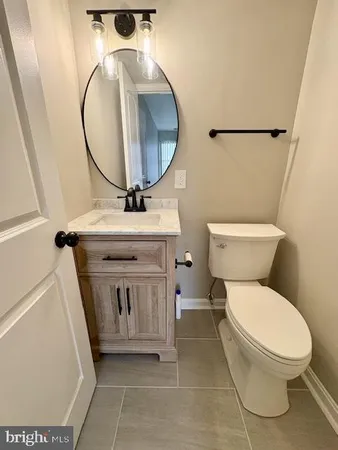 a bathroom with a toilet a sink and a mirror