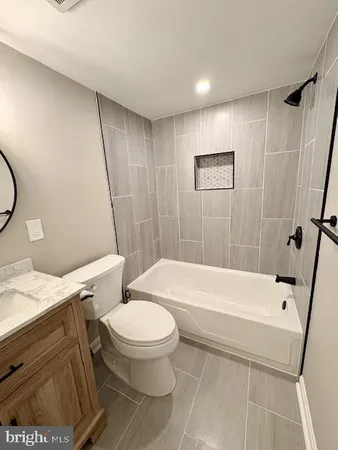 a bathroom with a toilet and a tub