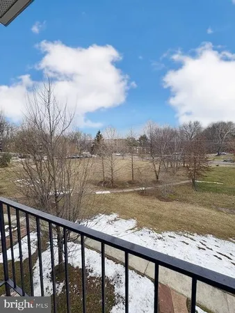 a view of a yard and car parked on the road