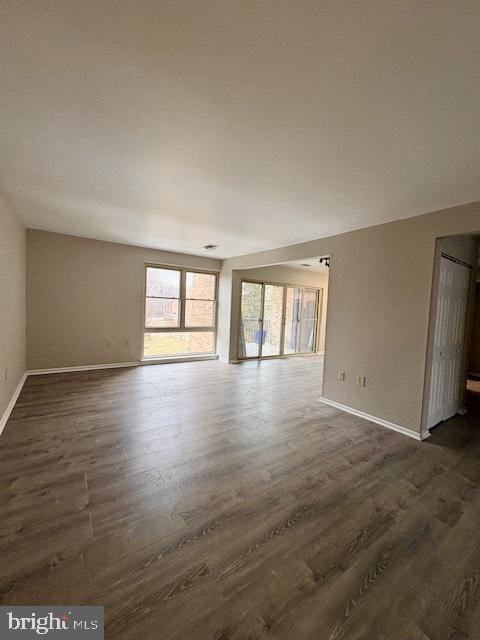 2109 Greenery Lane, Unit 30224 Silver Spring, MD 20906 - Photo 4 of 17 an empty room with wooden floor and windows