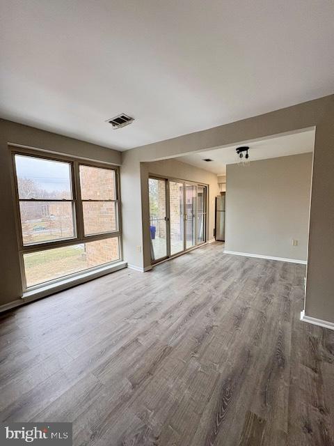 2109 Greenery Lane, Unit 30224 Silver Spring, MD 20906 - Photo 5 of 17 wooden floor in an empty room with a window