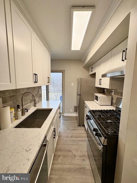 2109 Greenery Lane, Unit 30224 Silver Spring, MD 20906 - Photo 7 of 17 a kitchen with stainless steel appliances granite countertop a sink stove and refrigerator