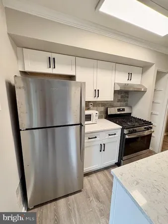 a kitchen with stainless steel appliances a refrigerator sink and stove