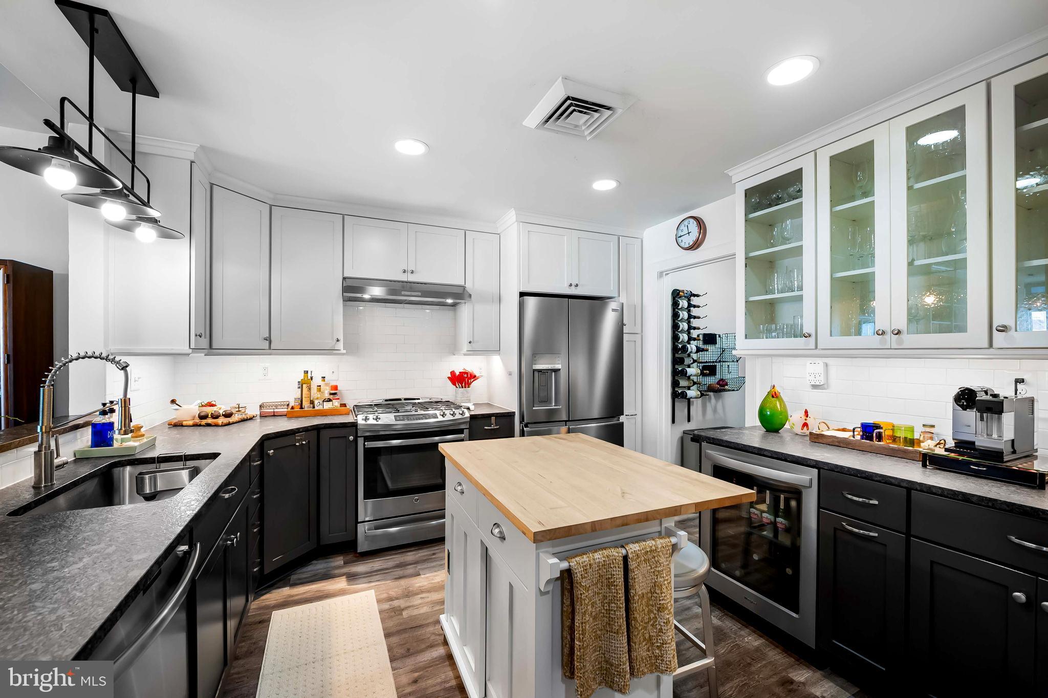 2901 Boston Street, Unit 513 Baltimore, MD 21224 - Photo 14 of 62 a kitchen with a stove a sink a refrigerator and cabinets