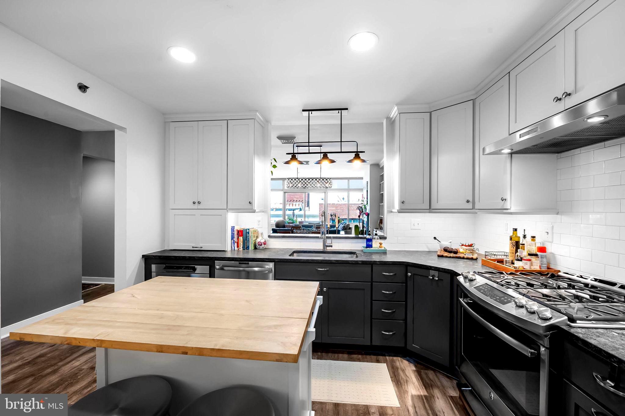 2901 Boston Street, Unit 513 Baltimore, MD 21224 - Photo 17 of 62 a kitchen with a sink a stove and cabinets