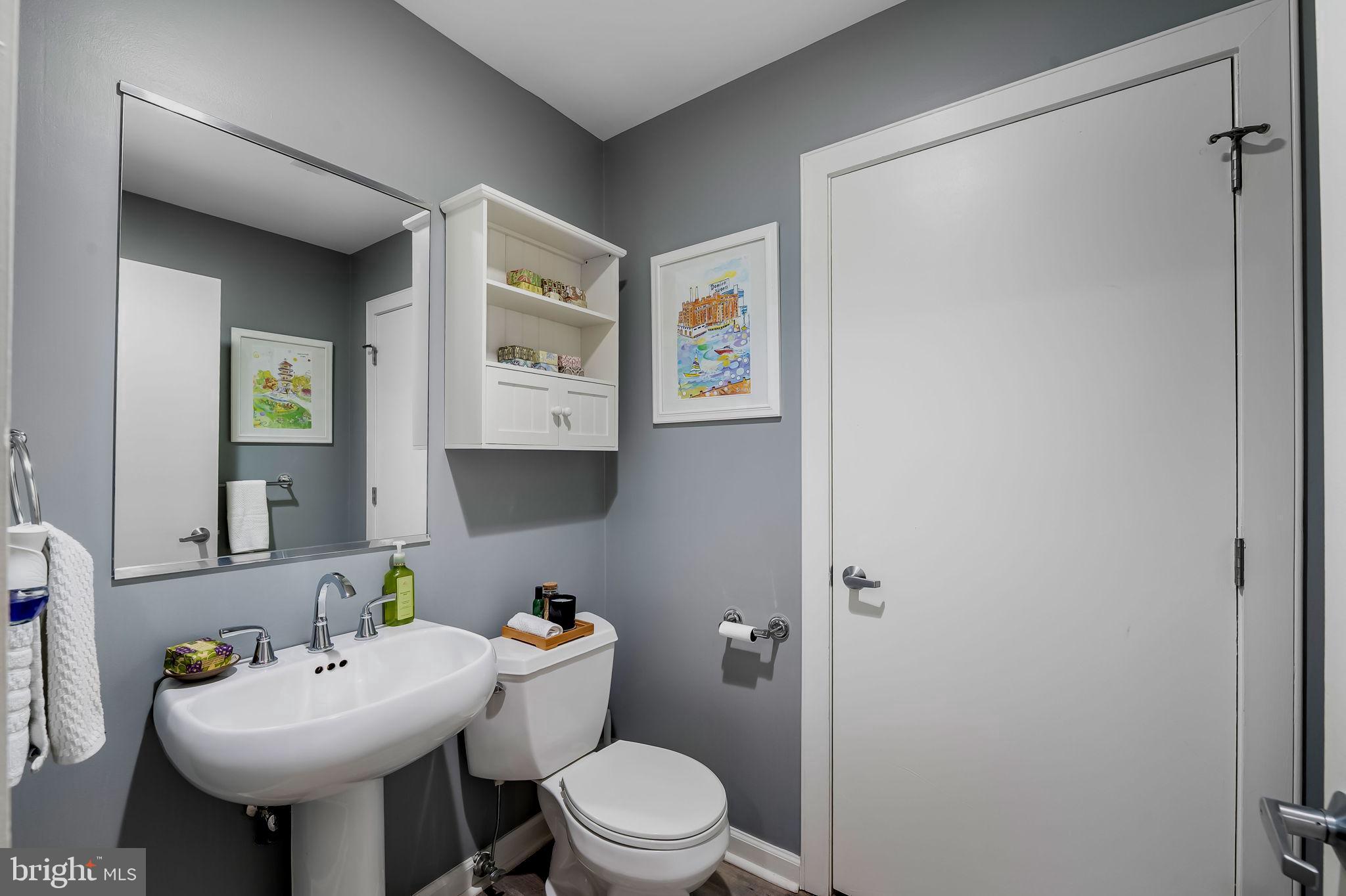 2901 Boston Street, Unit 513 Baltimore, MD 21224 - Photo 21 of 62 a bathroom with a toilet sink and mirror