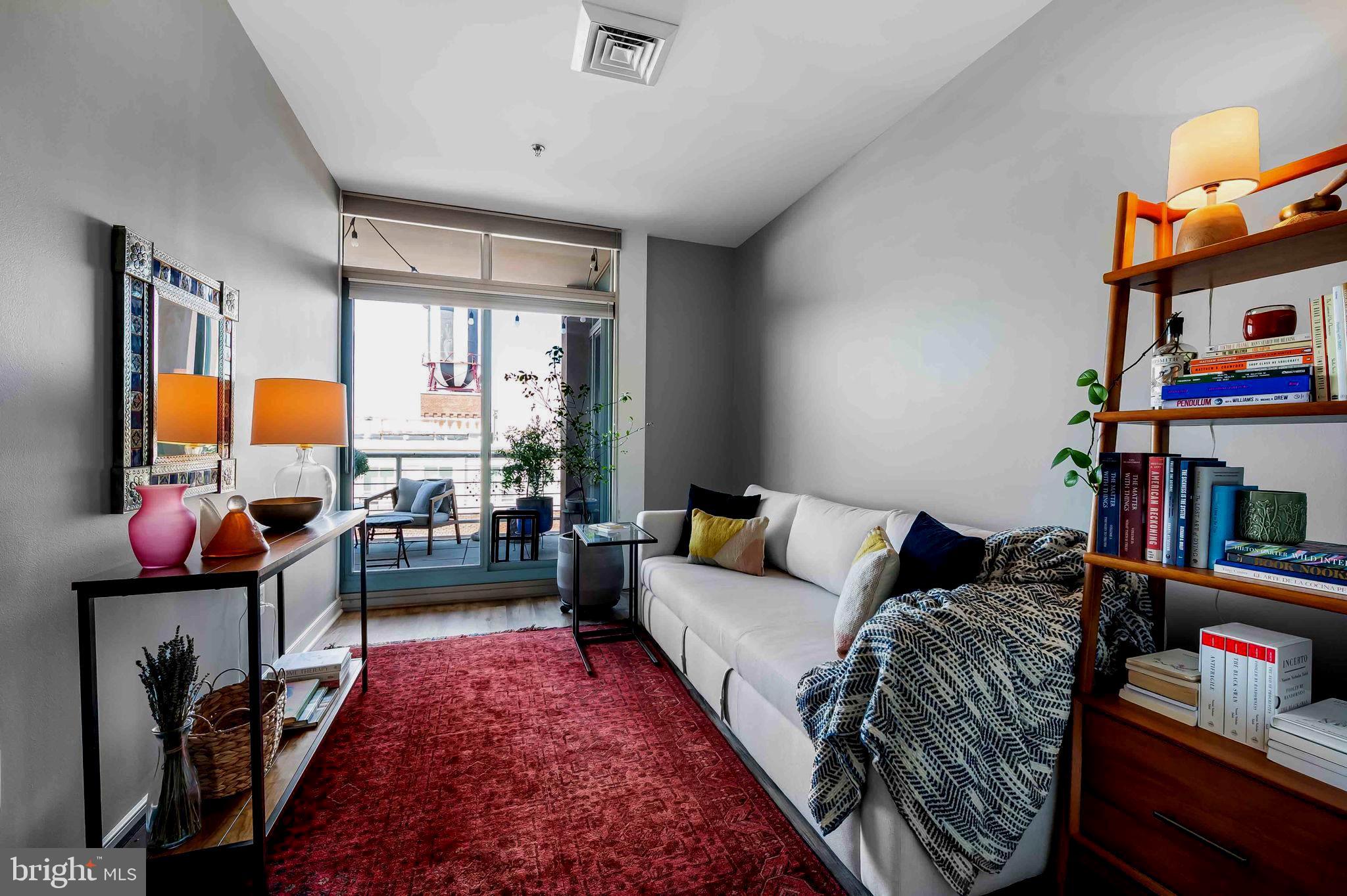 2901 Boston Street, Unit 513 Baltimore, MD 21224 - Photo 22 of 62 a living room with furniture flat screen tv and a window