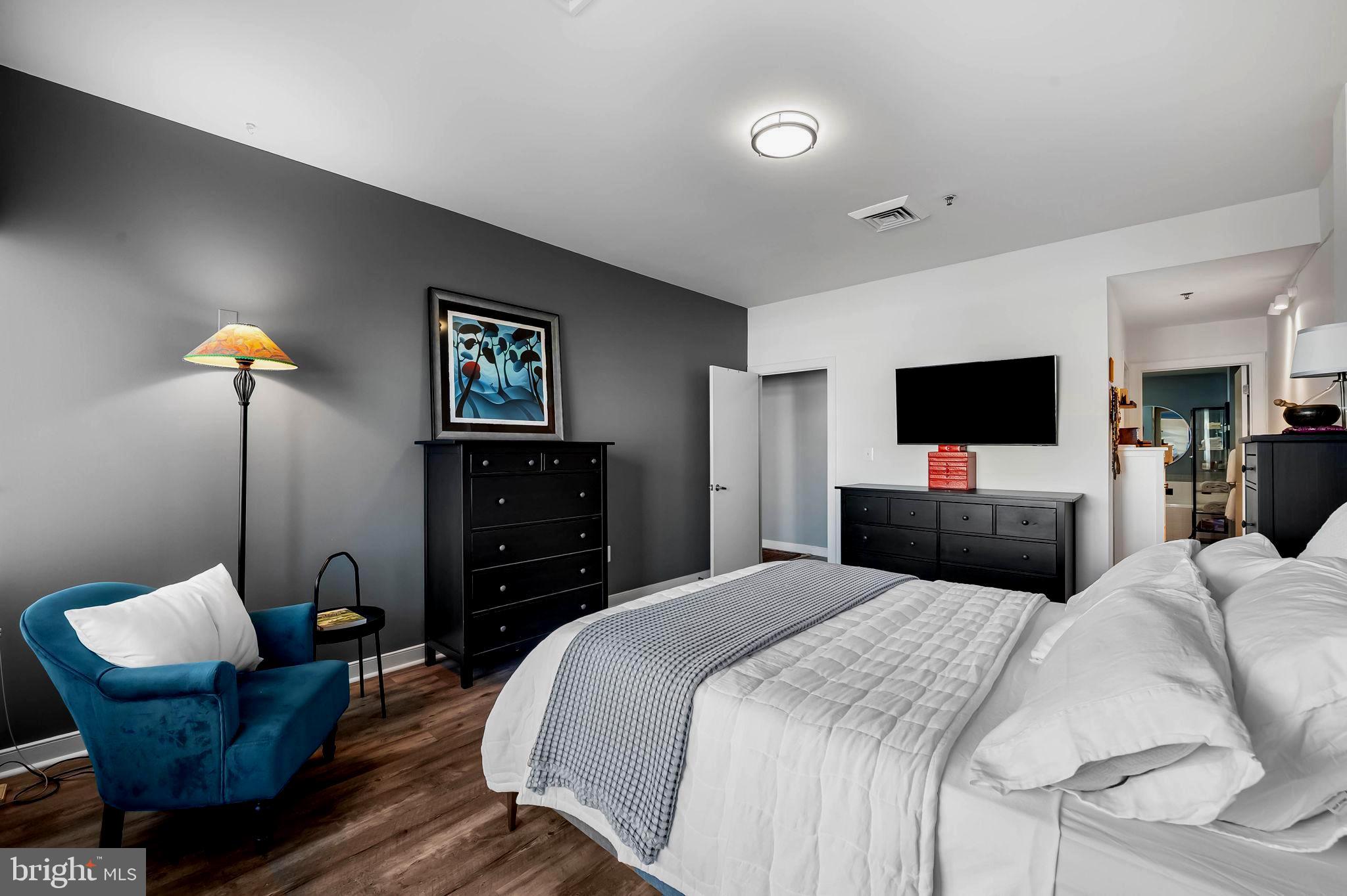 2901 Boston Street, Unit 513 Baltimore, MD 21224 - Photo 26 of 62 a bedroom with a bed and a television