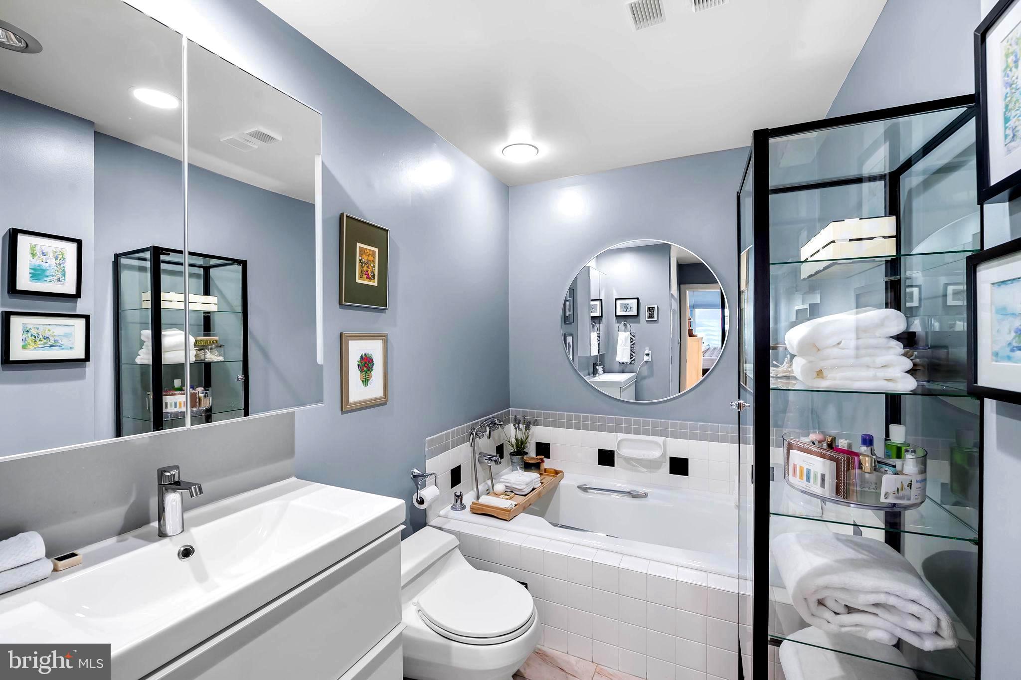 2901 Boston Street, Unit 513 Baltimore, MD 21224 - Photo 28 of 62 a bathroom with a sink vanity mirror and toilet