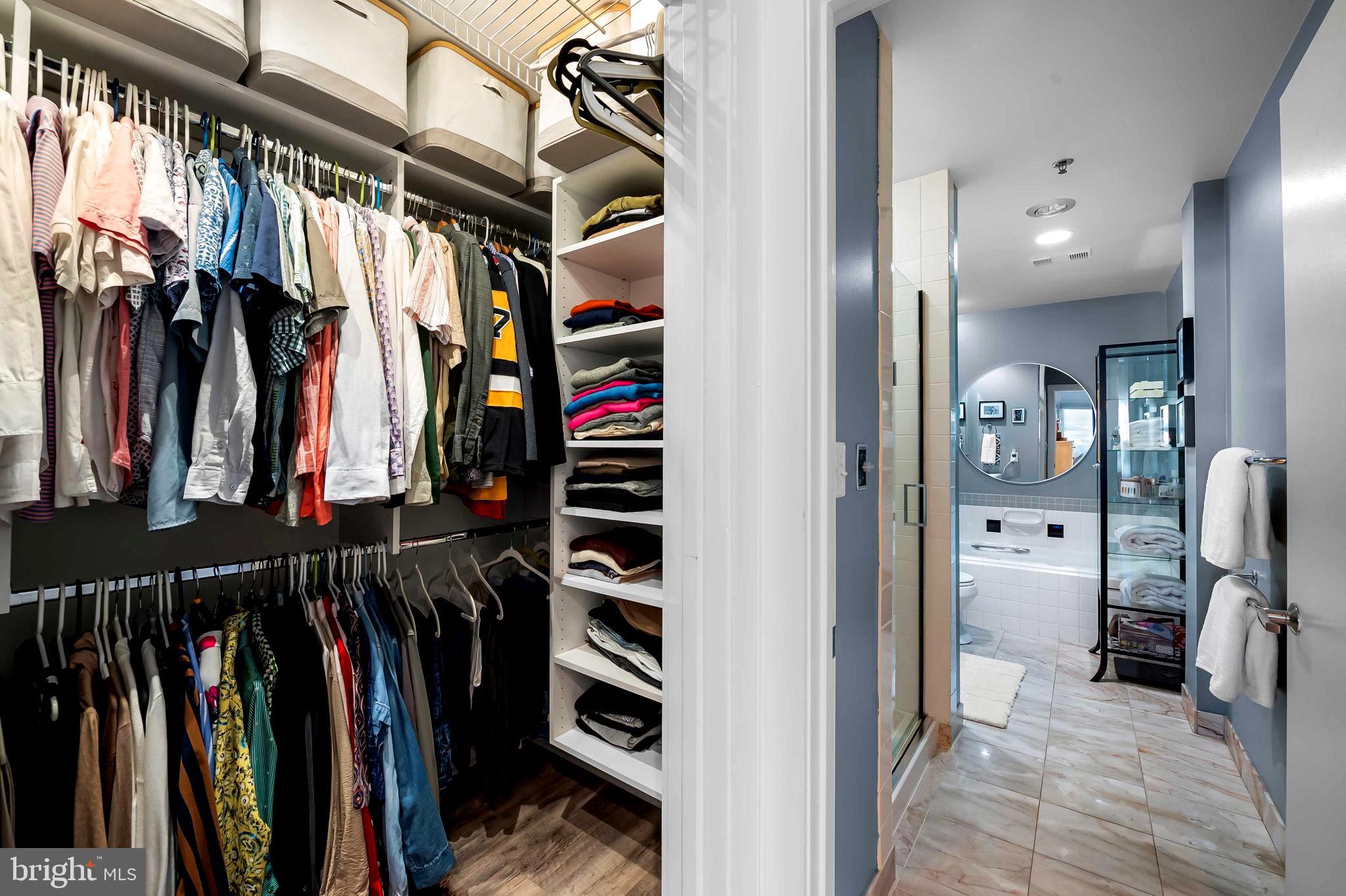 2901 Boston Street, Unit 513 Baltimore, MD 21224 - Photo 29 of 62 a view of walk in closet with clothes and shoes