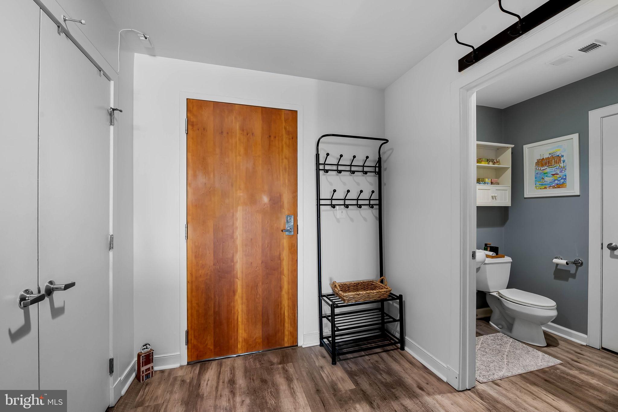 2901 Boston Street, Unit 513 Baltimore, MD 21224 - Photo 30 of 62 a view of bathroom with toilet front door and wooden floor