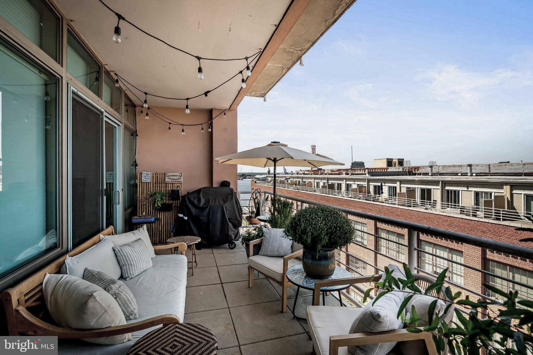 2901 Boston Street, Unit 513 Baltimore, MD 21224 - Photo 32 of 62 a roof deck with couches and potted plants