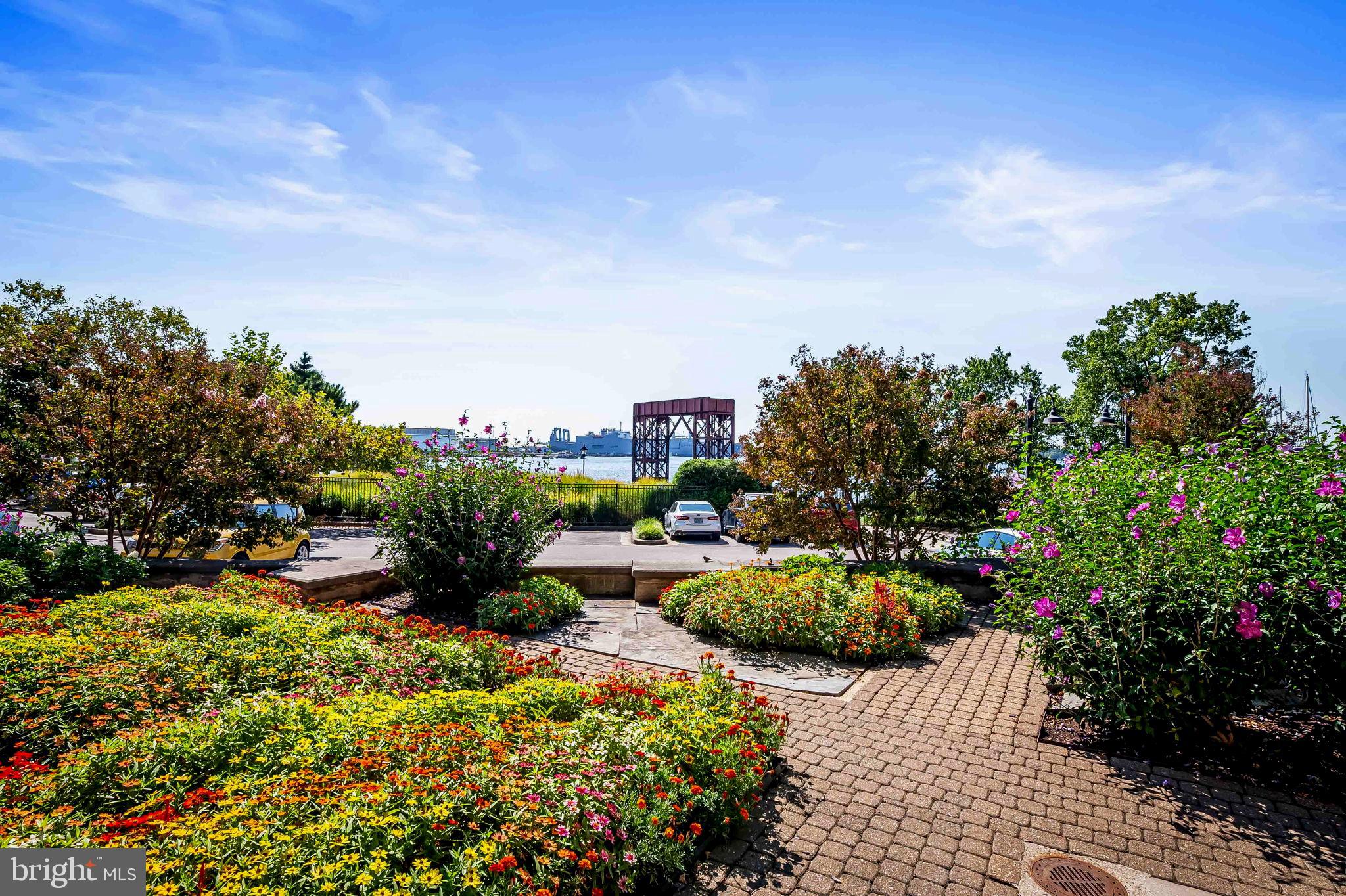 2901 Boston Street, Unit 513 Baltimore, MD 21224 - Photo 55 of 62 a view of a garden with a lot of flower plants and wooden fence