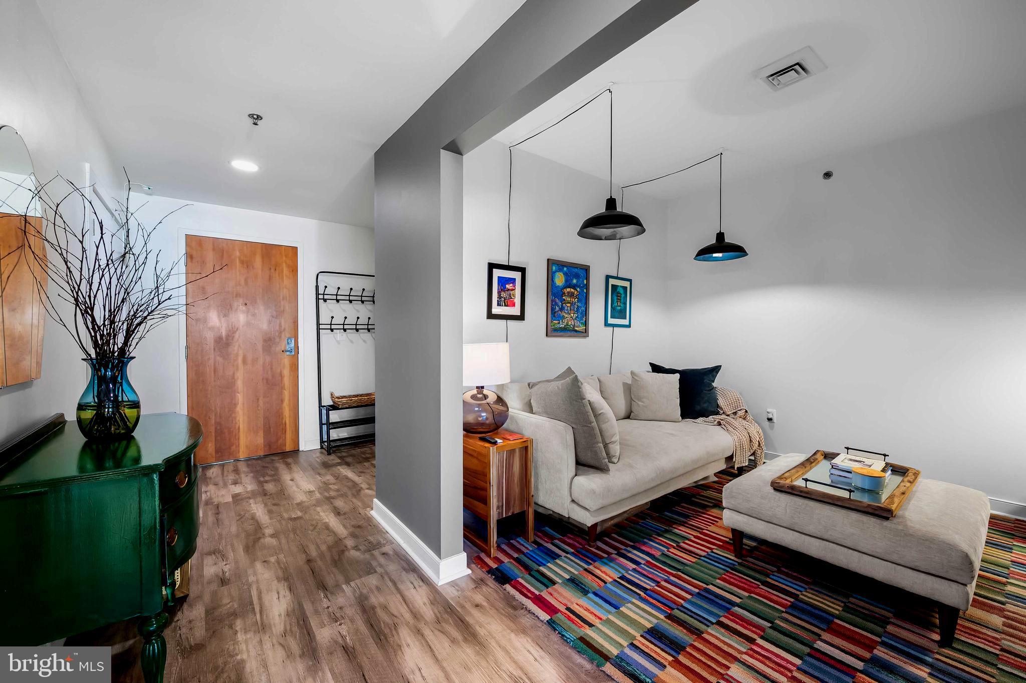 2901 Boston Street, Unit 513 Baltimore, MD 21224 - Photo 10 of 62 a living room with furniture and a wooden floor