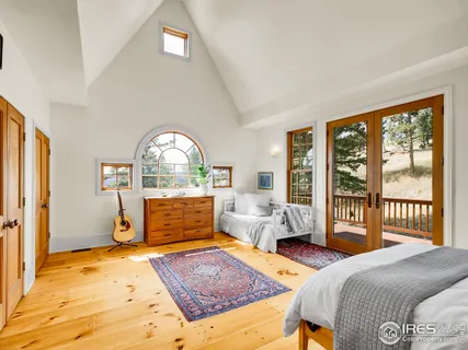 a living room with a bed furniture and a window