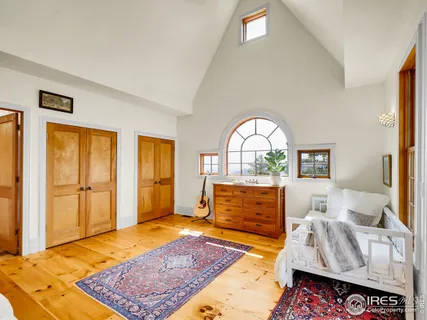 a bedroom with furniture and a rug