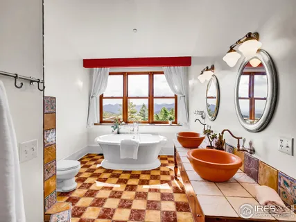 a bathroom with a toilet a sink and a window