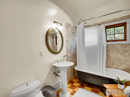 a bathroom with a sink mirror toilet and a shower