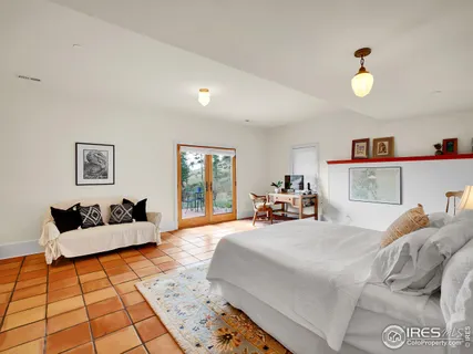 a bedroom with double bed and a couch