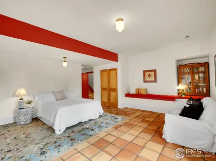 a bedroom with a bed and a couch