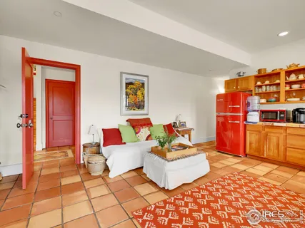 a living room with patio furniture and a rug