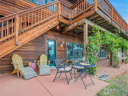 a view of a patio with a table and chairs