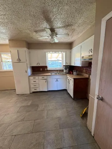 a view of a kitchen with a sink cabinets and a window