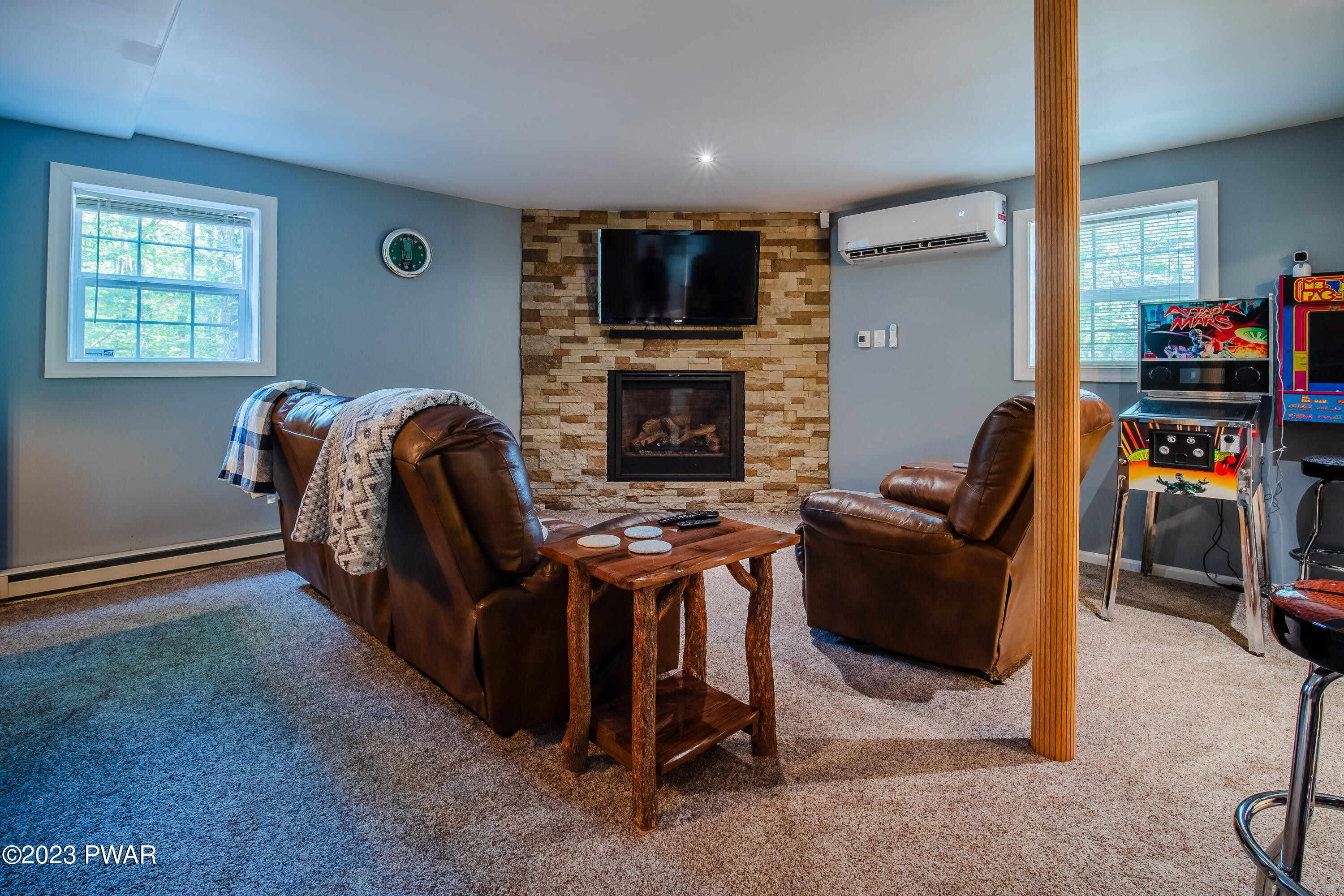 493 Northgate Road Lake Ariel, PA 18436 - Photo 31 of 37 a living room with furniture a fireplace and a flat screen tv